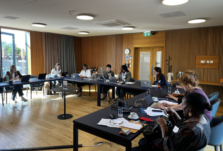 Workshop in action, participants sit round tables.